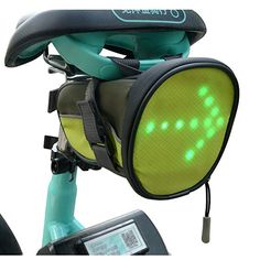 a bicycle with a back pack on it's seat and the front light turned green