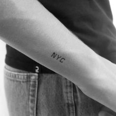 a person's arm with the word nye tattooed on it, in black and white