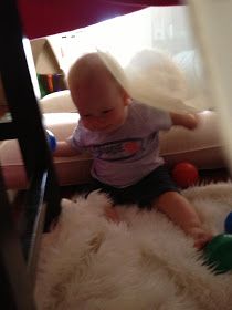 a baby sitting on the floor playing with toys