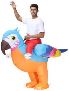 a man is riding on an inflatable bird