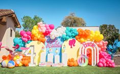 an outdoor birthday party with balloons and decorations