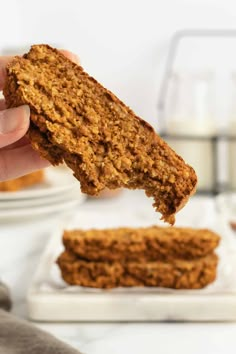 a person holding up a piece of bread