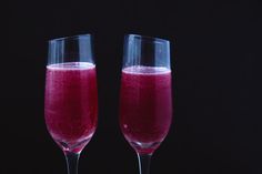 two wine glasses filled with red liquid