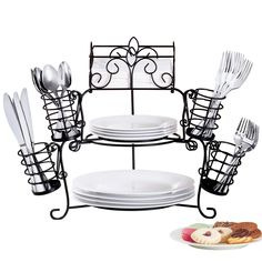 there is a plate and silverware on the stand with utensils in it