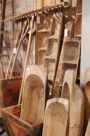 several wooden objects are stacked up in a storage area, including paddles and other woodworking tools