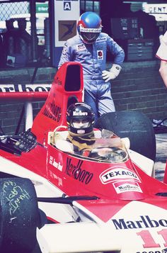 a man standing next to a racing car