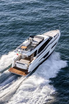 a white boat is traveling through the water