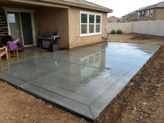 a concrete patio being built in front of a house