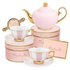 a pink tea set with gold trimming