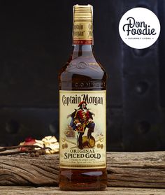 a bottle of captain morgan's spiced gold syrup on top of a wooden table