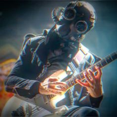 a man in gas mask playing an electric guitar