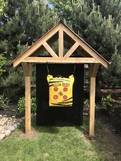 a wooden structure with a yellow sign on it