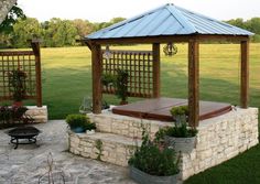 a gazebo sitting on top of a lush green field