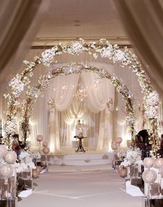 the aisle is decorated with flowers and candles