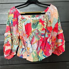 Never Worn Blouse That Is Fantastic For Summer And Vacations. Light Fabric With Beautiful Floral Tropical Pattern. Off The Shoulder And Cropped Fit With Elastics At Neckline And Bottom. Printed Pink Summer Top, Summer Pink Tops With Floral Print, Chic Multicolor Tropical Print Tops, Vibrant Print Blouse For Vacation, Pink Floral Print Top For Summer, Pink Floral Print Tops For Summer, Long Sleeve Pink Crop Top For Summer, Summer Pink Blouse With Tropical Print, Summer Blouse With Tropical Print In Pink