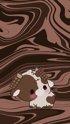 a brown and white cow sitting on top of a wooden floor next to a wall