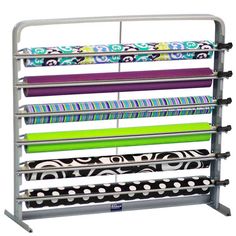 a rack that has many different colored fabrics on it and is holding several rolls of fabric