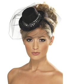 a woman wearing a black hat with veil on it's head and her hair in a bun