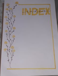 an index book with yellow flowers on the front and back cover, sitting on a table