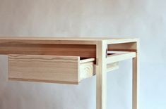 a wooden desk with two drawers on it