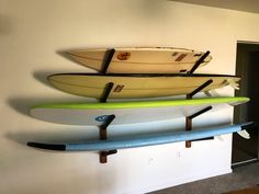 three surfboards are hanging on the wall