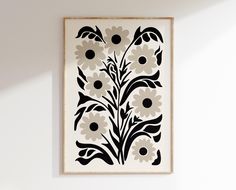 a black and white floral print hangs on the wall