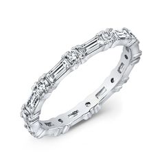 a white gold wedding band with baguetts and diamonds on the sides, set in 18k white gold