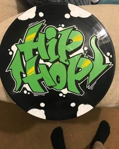 a black and green frisbee with graffiti on it