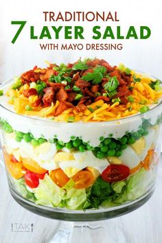 a layered salad in a glass dish with the title traditional 7 layer salad with mayo dressing