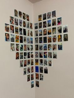 a heart shaped photo collage on the wall