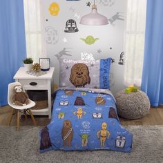 a child's bedroom with star wars themed bedding and blue droid curtains