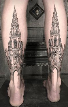 the legs are covered in black and white ink with a clock tower on it's side