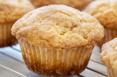 some muffins are sitting on a table with strawberries