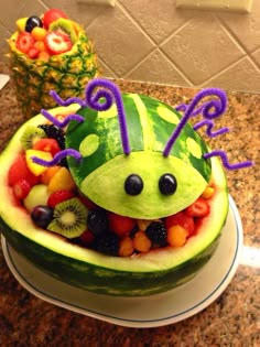 a watermelon shaped like a caterpillar with fruit in the shape of it