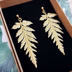 Real fern leaf earrings gold made from brass, Nature-inspired jewelry, Botanical beauty Gifts for Her, Artistic jewelry inspired by plants. Fern leaf earrings made from brass with gold plated 925 sterling silver fasteners without any nickel content, ensuring they are hypoallergenic and safe for sensitive skin. Design based on the pattern of real leaves. The earrings are delicately crafted from jewelry brass showcasing real fern leaves that measure 5 cm in length. You have the option to select from two clasps - a secure pin clasp featuring a ball or English lever-back ear wires with a convenient latch. Rest easy knowing that our earrings are designed with your comfort in mind. The clasp is made of 925 sterling silver covered with gold, completely free from nickel additives, ensuring that ev Leaf Earrings Gold, Fern Earrings, Fern Necklace, Fern Leaves, Botanical Earrings, Fern Leaf, Skin Design, Real Leaves, Nature Earrings