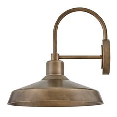 an antique brass finish wall light with a metal arm and round, dome shaped shade