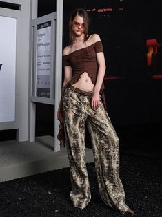 Striking pants in a muted earth-tone abstract print. Features a high waist and dramatically flowing silhouette. Unique pattern resembles organic textures or camouflage. Luxurious fabric drapes elegantly to the floor. Perfect for making a bold statement in haute couture or avant-garde fashion contexts. Model: 173cm/48kg Wearing size M North Node, Arcana Archive, Flower Retro, Avant Garde Fashion, Pants Suit, Printed Trousers, Draped Fabric, Pitcairn Islands, British Indian