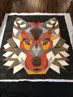 a quilt made to look like a wolf's head