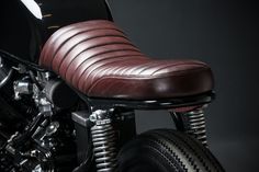 a close up of a motorcycle with a leather seat