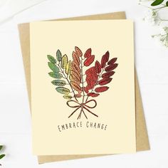 a card with the words embrace change on it and an image of leaves in red, green