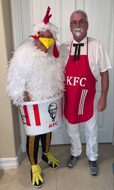 two people dressed as chicken and roosters in aprons standing next to each other