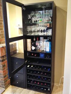 a wine rack with many bottles and glasses