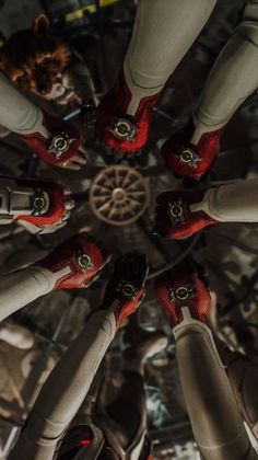 several pairs of red shoes are arranged in a circle on top of each other,