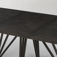 a wooden table with four legs and a black top