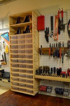 a room with several shelves and various tools on the wall, including shoes hanging from pegboards