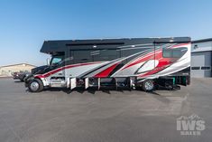 an rv parked in a parking lot next to a building