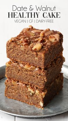 three brownies stacked on top of each other in front of the words, date and walnut healthy cake vegan 1 of 1 dairy - free