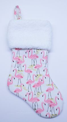 a pink flamingo christmas stocking with white fur