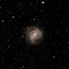 an image of a spiral galaxy in the sky