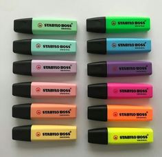 several different colored pens are lined up in a row on a white surface with the words stabio dogs written on them